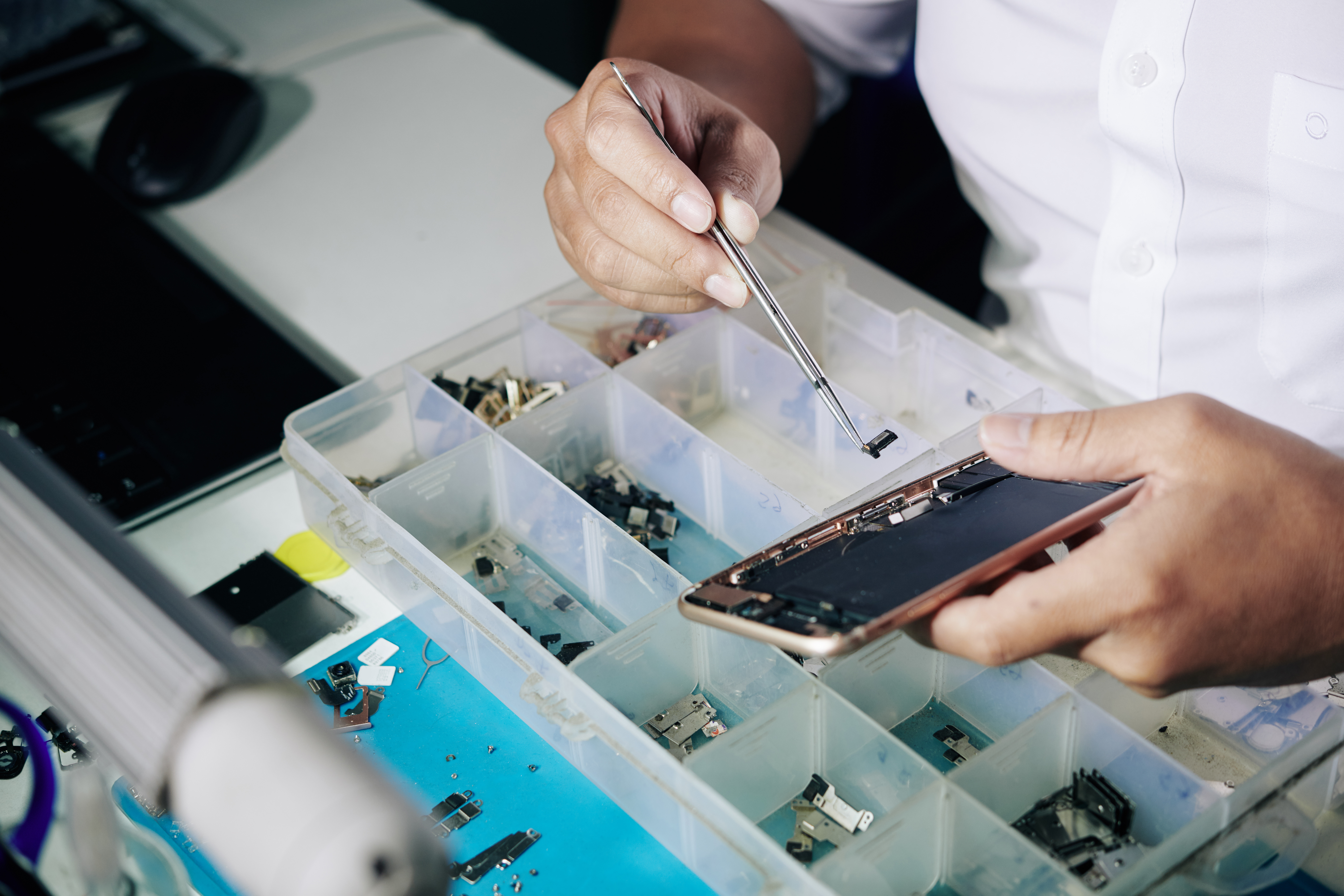 Repairman fixing broken smartphone