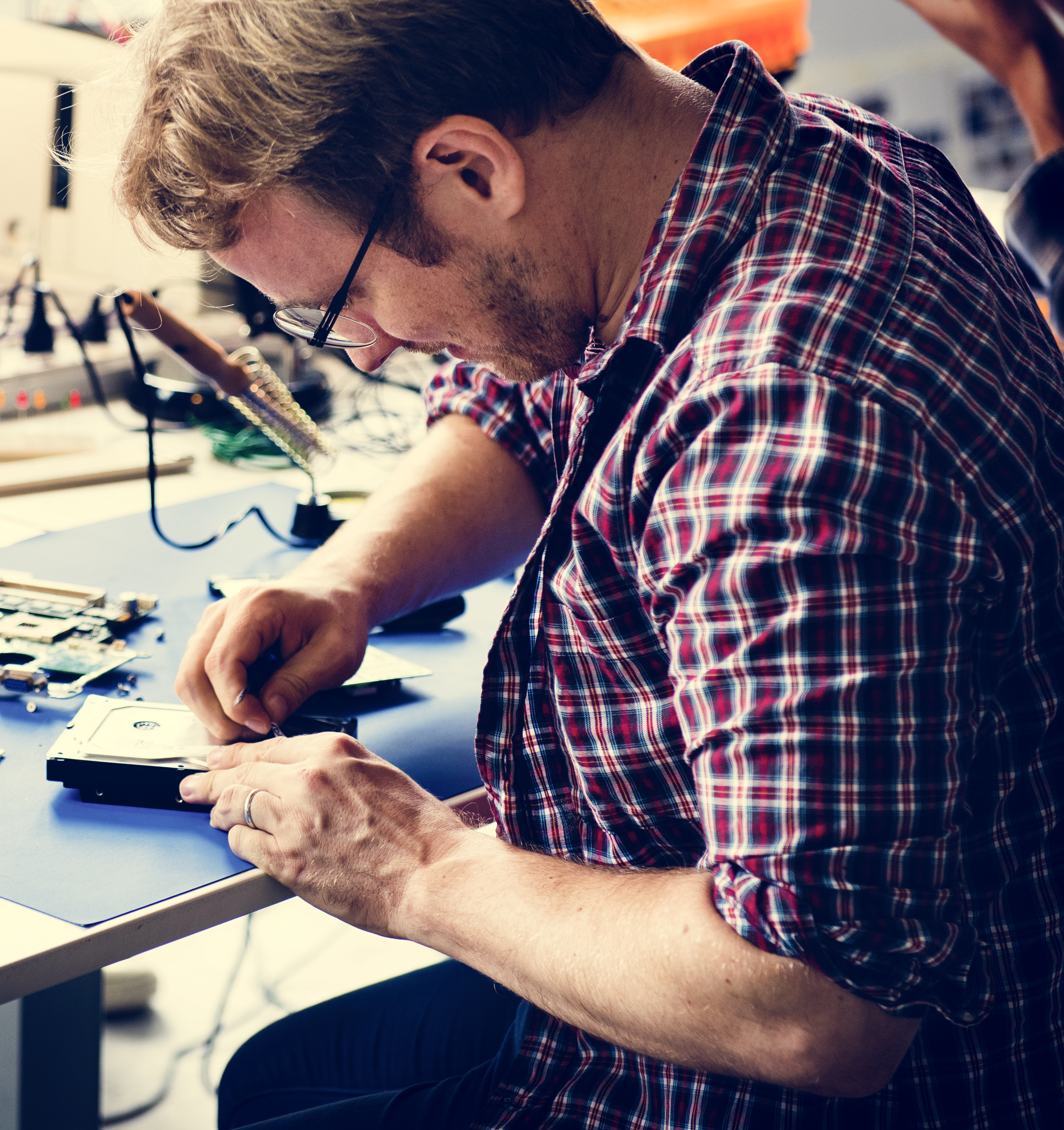 Technicians working on computer hard disk